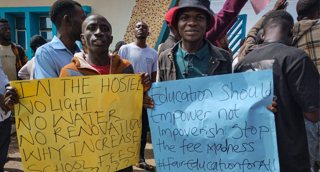 UNIJOS students held up signs with different messages to express their demand