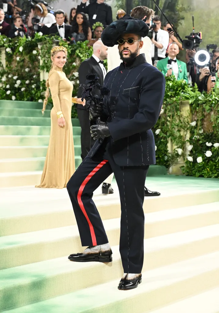 Bad Bunny holding a black rose bouquet.