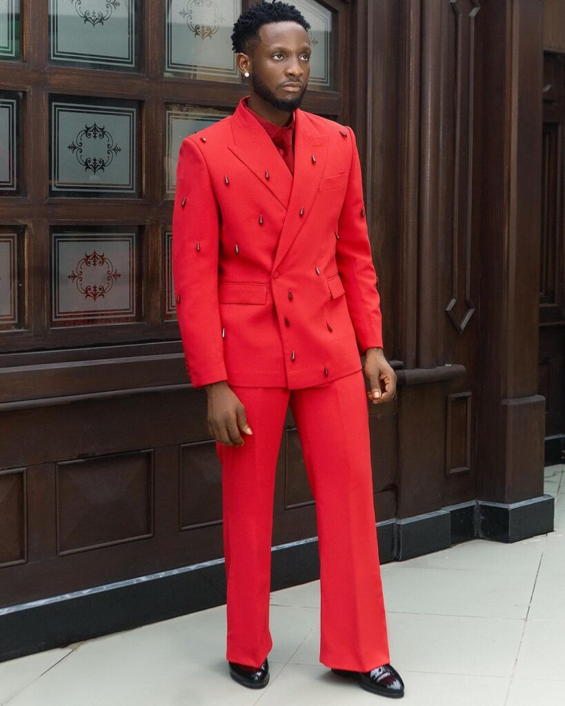 Chimozie Imo in a red suit .