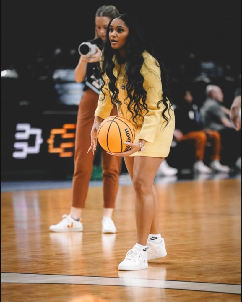 Sydney handling a basketball in a bright yellow outfit 
Credit:- Sydney Carter|Instagram