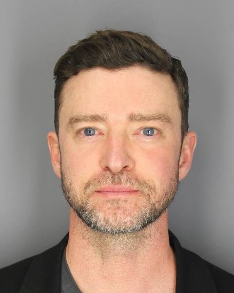 A young middle-aged white man with blue eyes and a trim blond beard with some gray looks directly at camera.