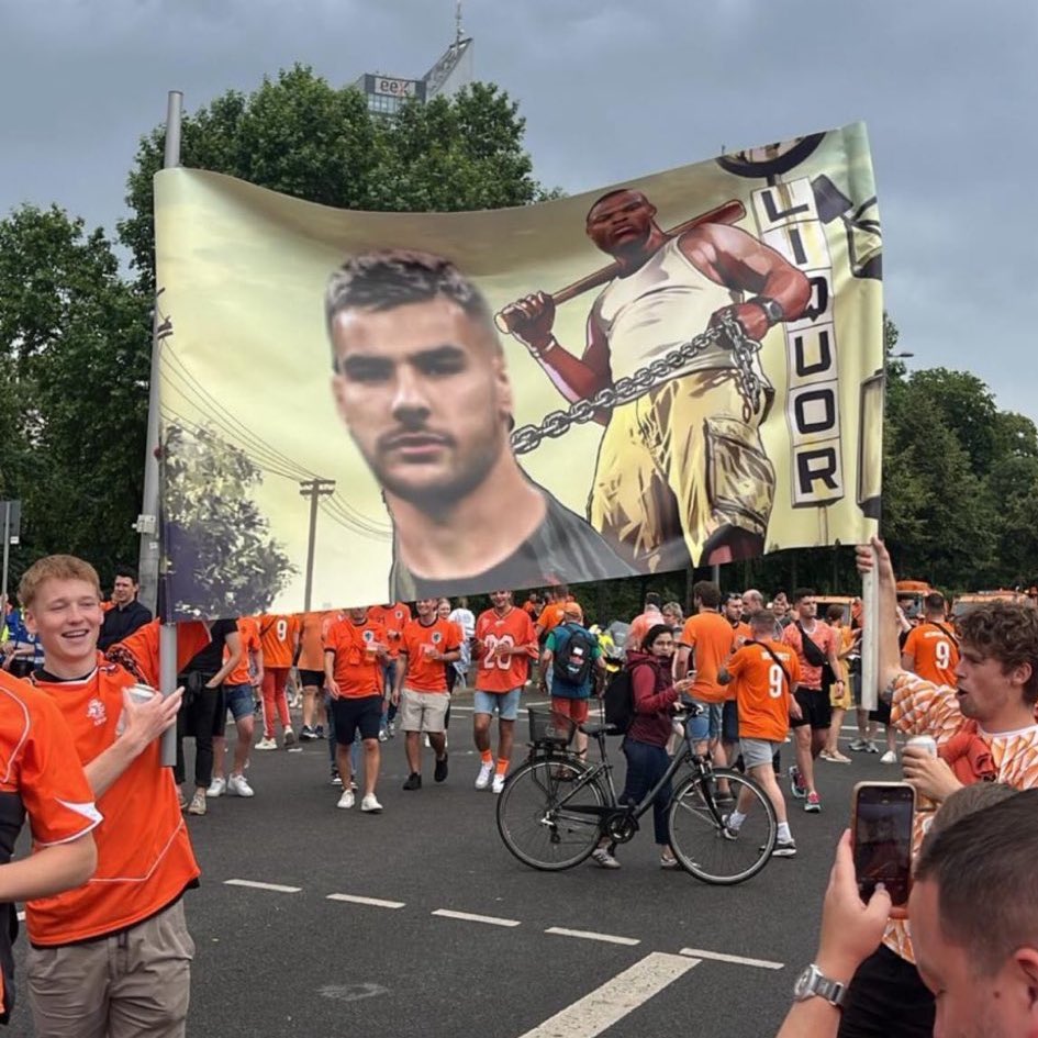 Dutch fans once again carrying a banner of Denzel Dumfries, a Netherlands player holding on to French player, Theo Hernandez with a leash (Photo Credit: X)