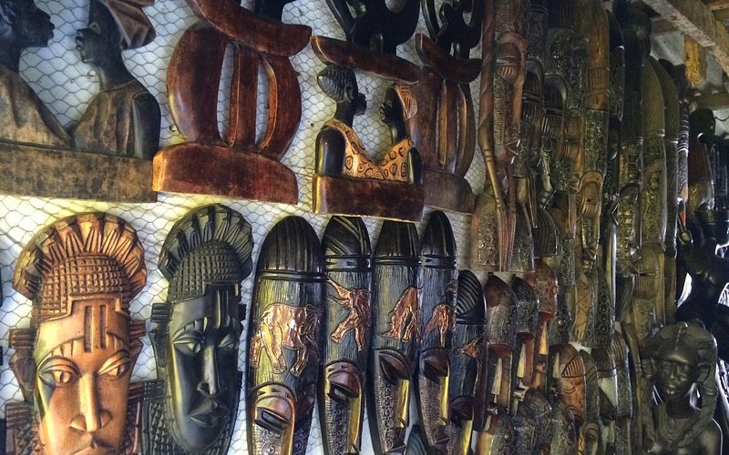 A wall of handcrafted masks, representing different Nigerian cultures, sold at the Lekki Art and Crafts Market.