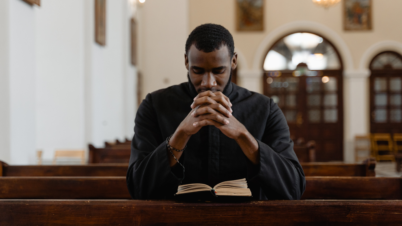 Black man praying in church