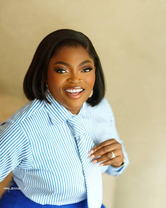 Funke Akindele in an aso-oke skirt and striped shirt