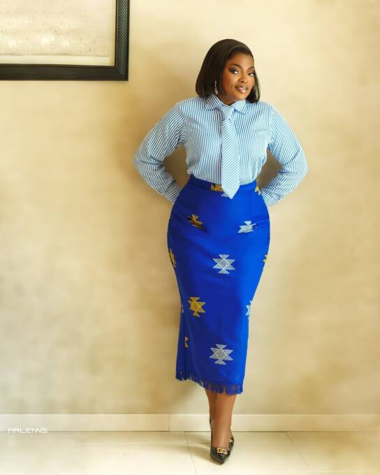 Funke Akindele in an aso-oke skirt and striped shirt
