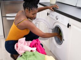 A woman using a washing machine/home appliance